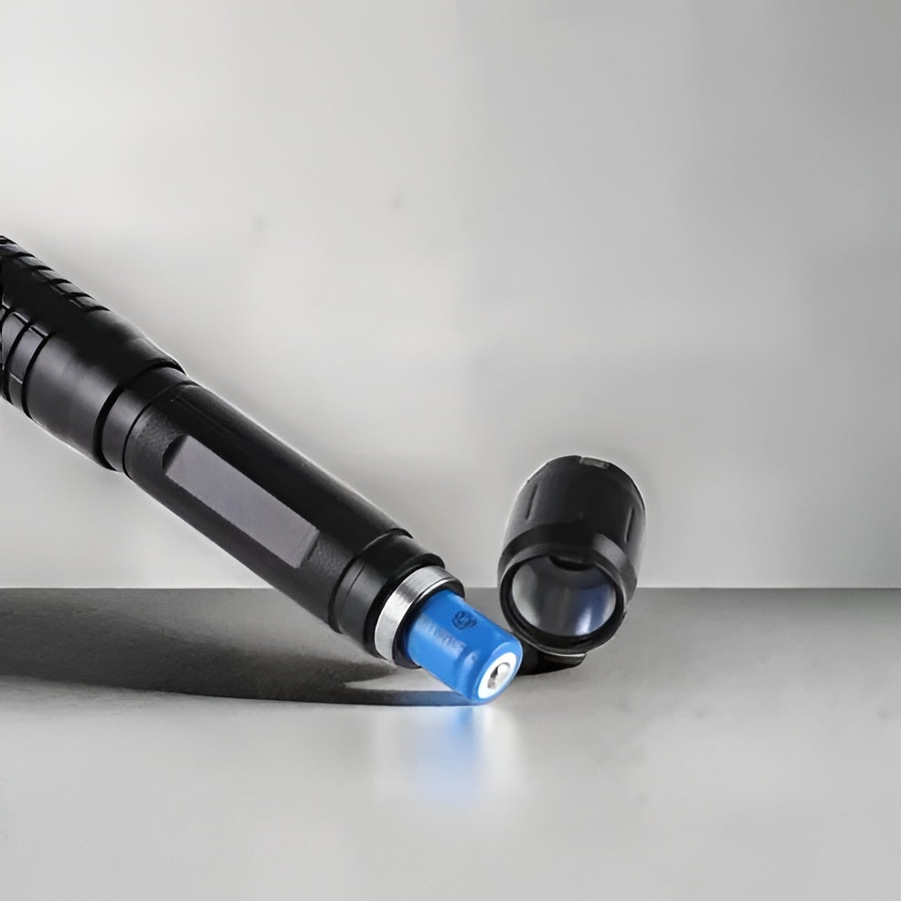 Tactical Flashlight With Integrated Laser Sight And Adjustable Beam